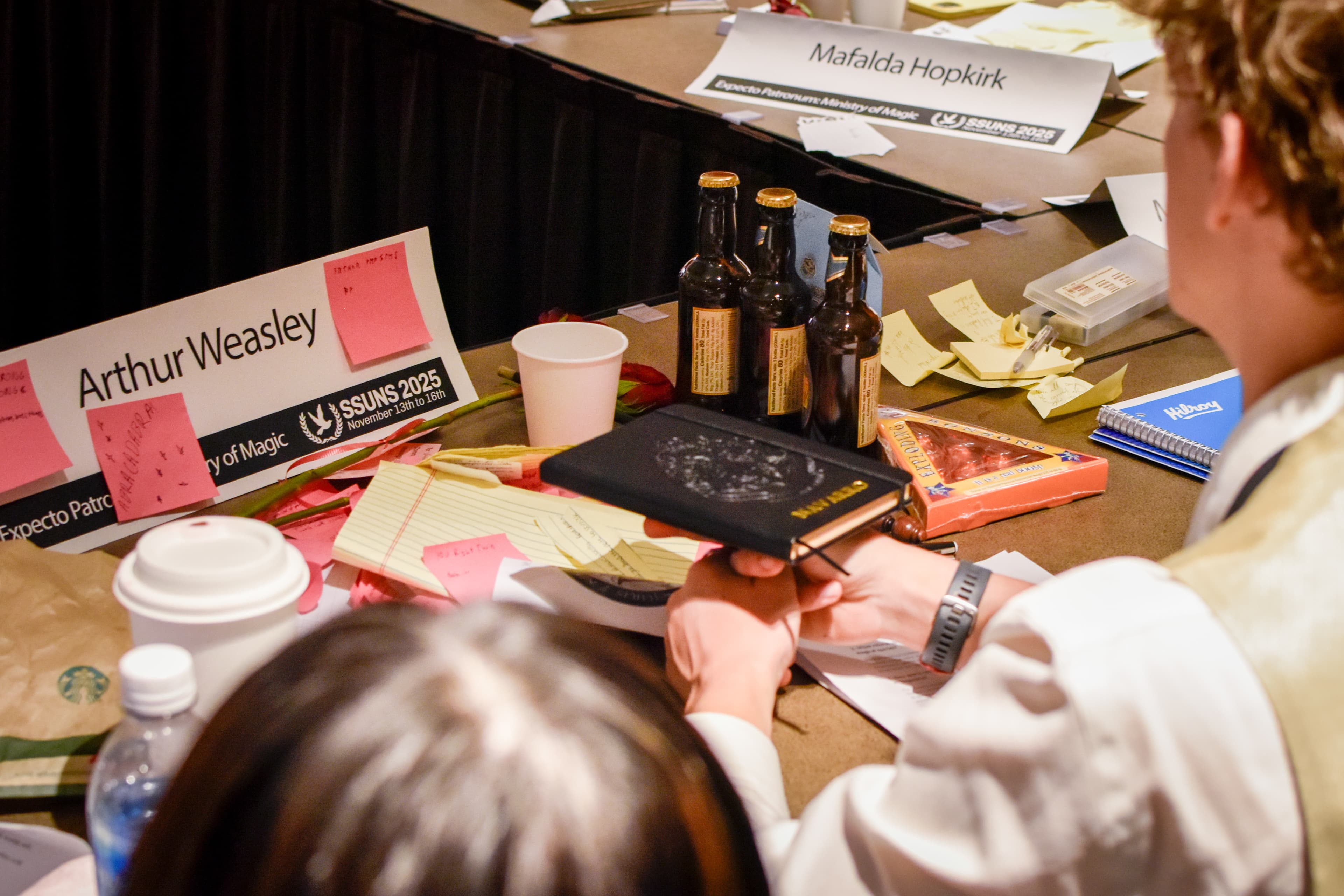 Delegates consulting notes before debate
